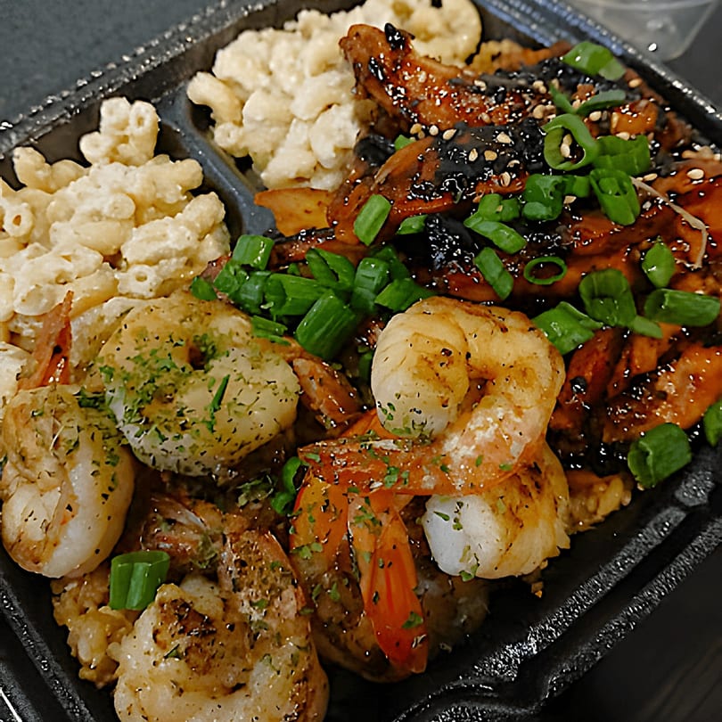 A Sharky's Island Bites plate with grilled shrimp, teriyaki chicken, and macaroni salad.