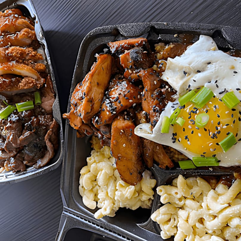 Two Sharky's Island Bites poke bowls with chicken, beef, mac salad, and a fried egg.
