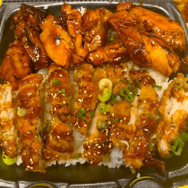 A Sharky's Island Bites poke bowl with teriyaki chicken and crispy chicken katsu over rice.